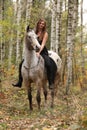 Young girl with appaloosa horse in autumn Royalty Free Stock Photo