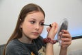Young girl applying make up for fun Royalty Free Stock Photo