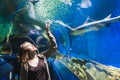 Young Girl In Aquarium Tunnel With Sharks