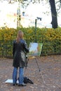 Girl artist painting an autumn landscape Royalty Free Stock Photo