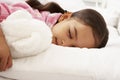 Young Girl Asleep In Bed With Cuddly Toy Royalty Free Stock Photo