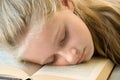 Young girl asleep in a book Royalty Free Stock Photo