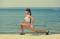 Young girl athlete, in shorts and top running on the beach in summer, morning exercise Royalty Free Stock Photo