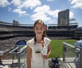 Young Girl attending her first professional baseball game. Smiling, happy and holding a churro