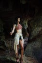 Young girl on the background of an old cave. The concept of harmony with nature . Royalty Free Stock Photo