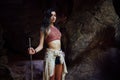 Young girl on the background of an old cave. The concept of harmony with nature . Royalty Free Stock Photo