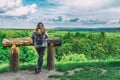 Young girl with a backpack looks at the beautiful nature. Travels. Solitude with nature