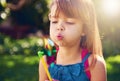 Young girl, backyard and blowing pinwheel, garden and enjoying freedom of outside and fun. Pretty little child, outdoor Royalty Free Stock Photo