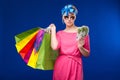 Young girl with bags and bunch of money in the hands of Royalty Free Stock Photo