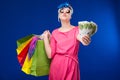 Young girl with bags and bunch of money in the hands of Royalty Free Stock Photo
