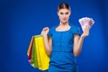 Young girl with bags and bunch of money in the hands of Royalty Free Stock Photo