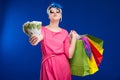 Young girl with bags and bunch of money in the hands of Royalty Free Stock Photo