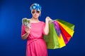 Young girl with bags and bunch of money in the hands of Royalty Free Stock Photo