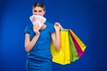 Young girl with bags and bunch of money in the hands of Royalty Free Stock Photo