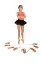 Young girl ballerina surrounded by ballet shoes ar