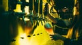 Young woman barman pouring a cold lager beer from tap to glass in neon light. Royalty Free Stock Photo