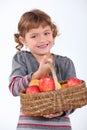 Young girl with a basket of apples Royalty Free Stock Photo