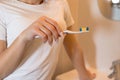 Young girl in the bathroom holds a toothbrush