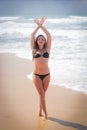 Young girl on the beach doing morning excercises Royalty Free Stock Photo