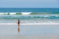 Young girl at the beach enjoying the waves