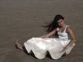 Young girl on beach with giant shell