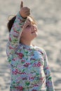 Young girl on beach with kite smiling Royalty Free Stock Photo