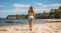 young girl on the beach, pretty girl walking on the beach, young woman running on the beach, backside view Royalty Free Stock Photo