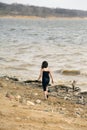 Young girl at the beach walking by the water Royalty Free Stock Photo