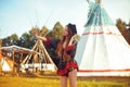 Young girl beautiful tourist take photo selfie, video communication and smiling, kiss on the background teepee / tipi- native indi