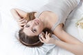 The young girl in bed listening to music Royalty Free Stock Photo