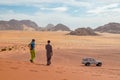 Young girl with bedouin local guide on a jeep tour on a vast Wadi Rum red sand desert, Middle East, Jordan Royalty Free Stock Photo