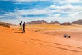 Young girl with bedouin local guide on a jeep tour on a vast Wadi Rum red sand desert, Middle East, Jordan Royalty Free Stock Photo