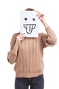 Girl covers her face with a white leaf with an emoticon with her tongue stick out on a white background