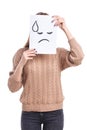Girl covers sheet with sad smiley with sweat on white background