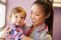 Young Girl Being Held By Female Pediatric Doctor