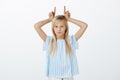 Young girl being stubborn, having no respect to adults. Portrait of indifferent confident cute daughter with blond hair