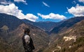 Young girl biker at mountain top with bright blue sky at day Royalty Free Stock Photo