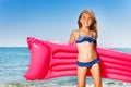 Young girl in bikini with pink inflatable mattress Royalty Free Stock Photo