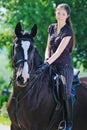 Young girl and black horse Royalty Free Stock Photo