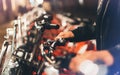 Young girl in black leather jacket using bike on background illumination glow bokeh light in night atmospheric city, hipster Royalty Free Stock Photo