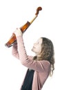 Young girl with blond curly hair holds violin up in studio Royalty Free Stock Photo