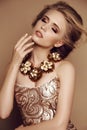 Young girl with blond hair and bright makeup with accessories