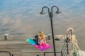 The girl is meditating on the terrace by the river Royalty Free Stock Photo