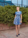 Young girl blonde in blue short dress Royalty Free Stock Photo