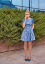 Young girl blonde in blue short dress Royalty Free Stock Photo
