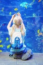 Young Girl Photographs Tropical Fish at Aquarium