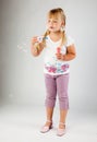 Young girl blow out soap bubbles Royalty Free Stock Photo