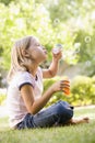 Young girl blowing bubbles outdoors Royalty Free Stock Photo