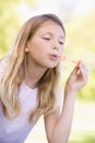 Young girl blowing bubbles outdoors Royalty Free Stock Photo