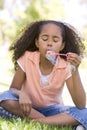 Young girl blowing bubbles outdoors Royalty Free Stock Photo